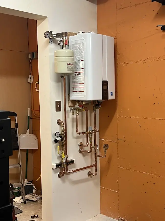 Plumbing technician inspecting water heater connections in Willow Oak